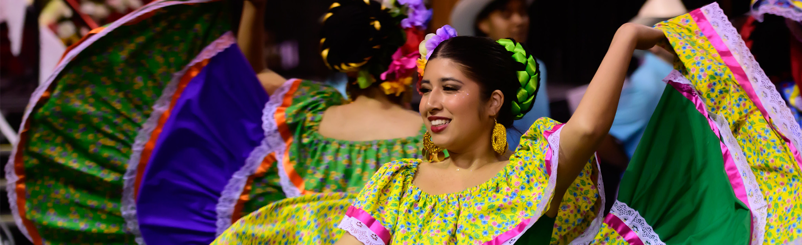 lady wearing traditional hispanic dress dancing